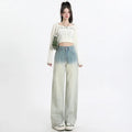 Gradient blue women's denim straight-leg trousers with a wide-leg fit on a hanger