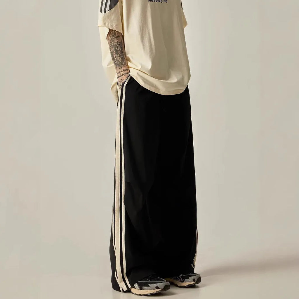 Black men's wide-leg high-waist climbing trousers laid flat, showing straight cut and polyester fabric.