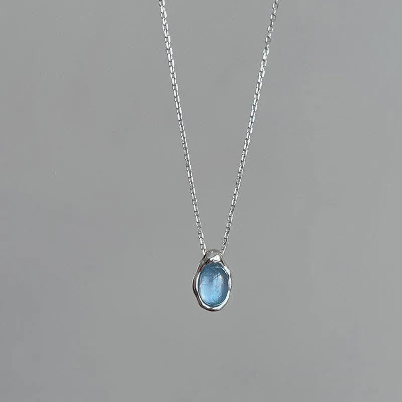 Navy blue water drop necklace with geometric design on adjustable cross chain