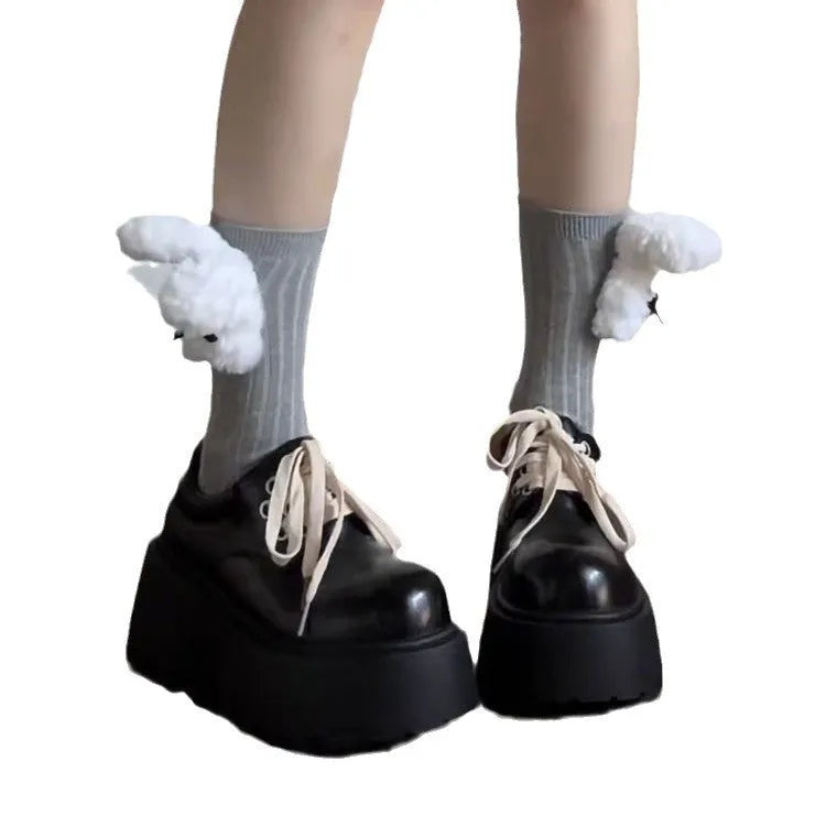 Women's matte black lace-up heeled shoes with thick rubber sole and block heel on a plain background