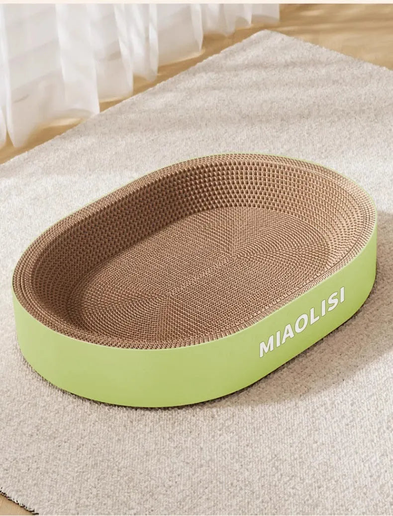 Green oval corrugated paper cat scratch board and nest bed, 55 cm in diameter.