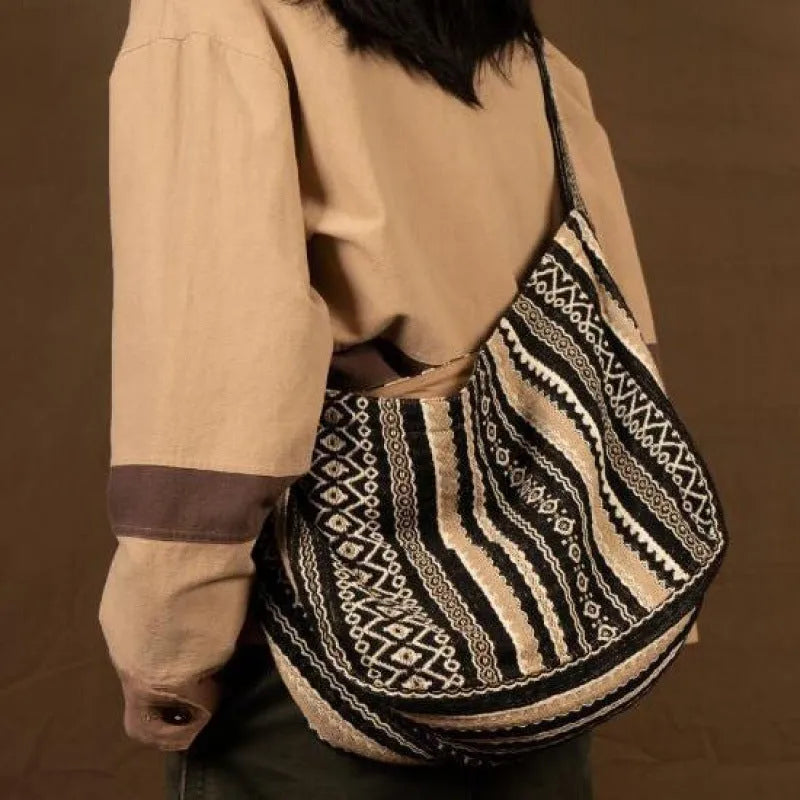 Retro striped corduroy messenger bag with jacquard detail and an adjustable plaid shoulder strap.