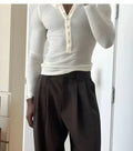 Men's cream-coloured cotton henley top with long sleeves and buttoned neck placket.
