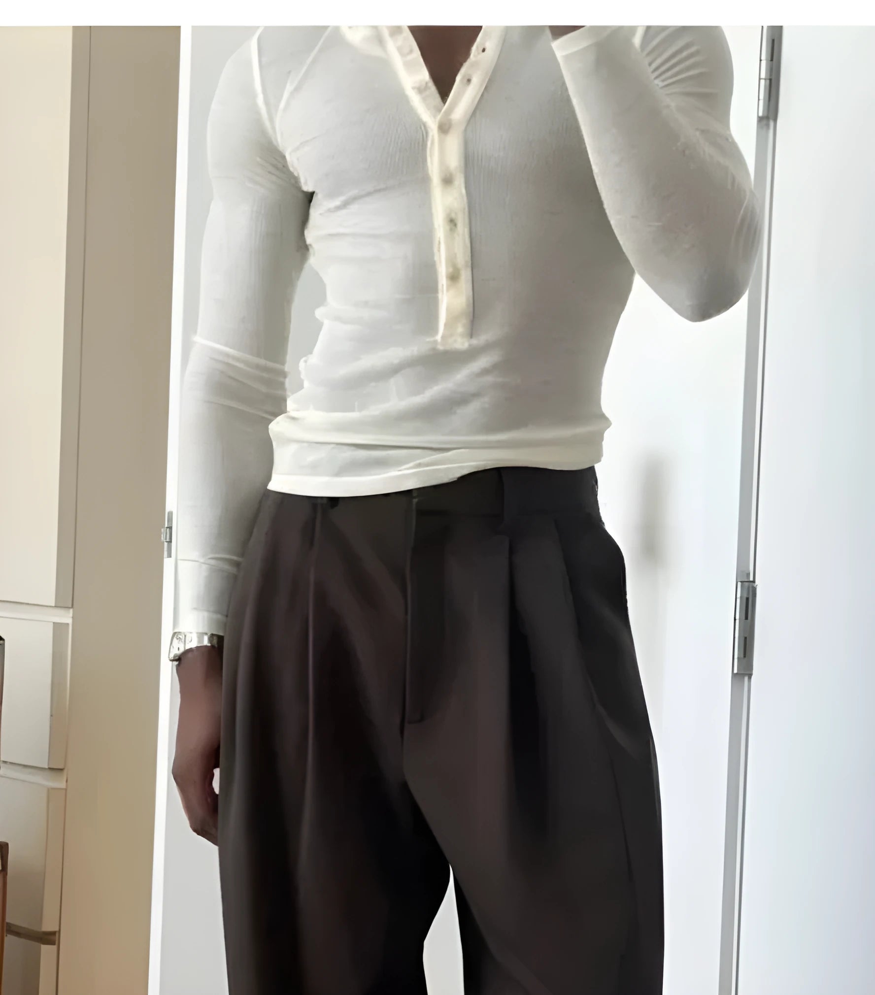 Men's cream-coloured cotton henley top with long sleeves and buttoned neck placket.