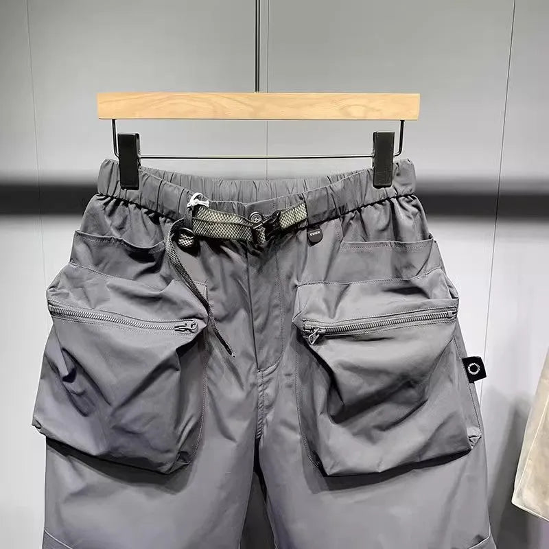 Men's black loose fit work shorts with pockets and straight leg hem above knee length