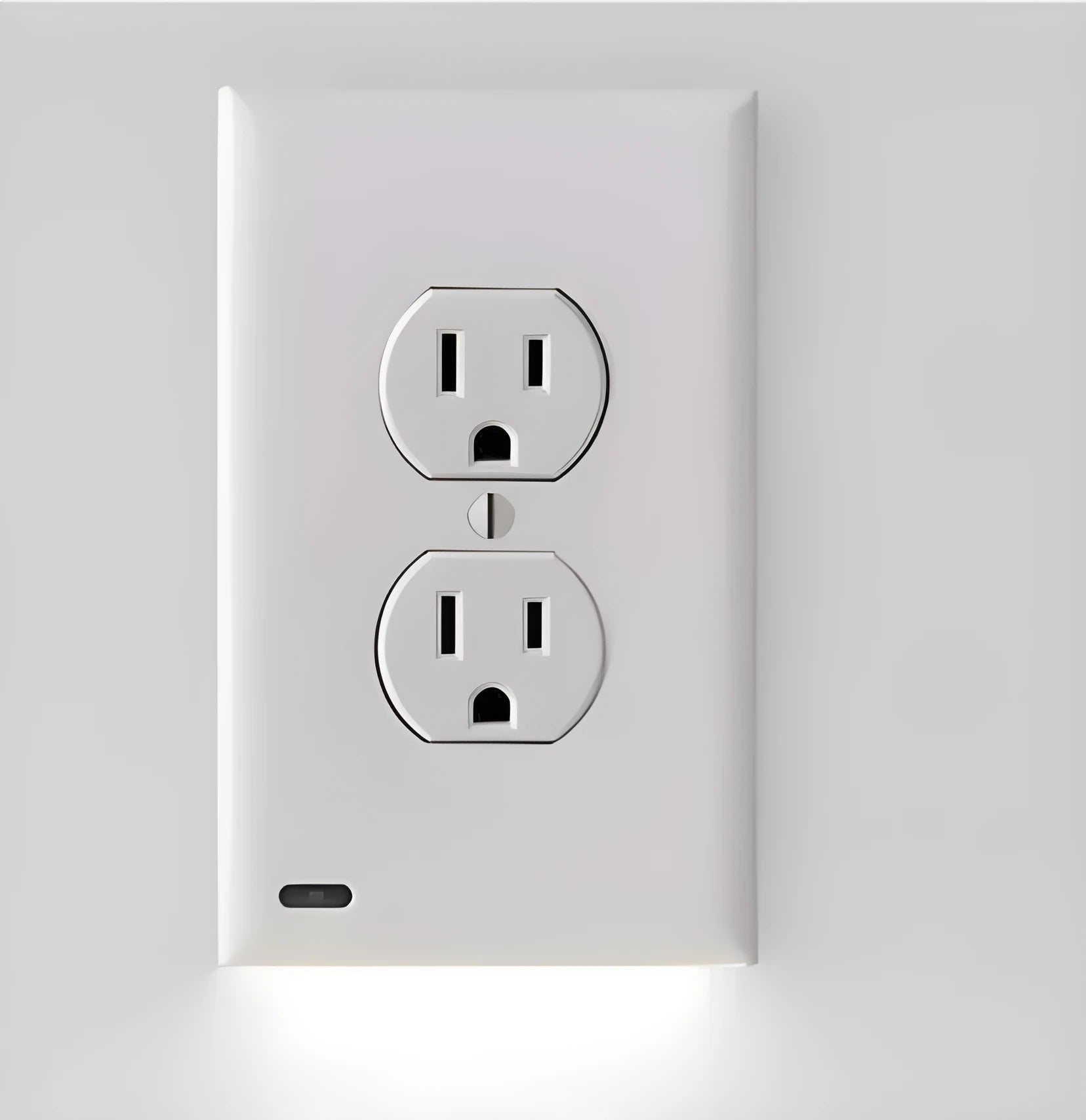 White plug-in socket induction LED night light installed in a wall outlet