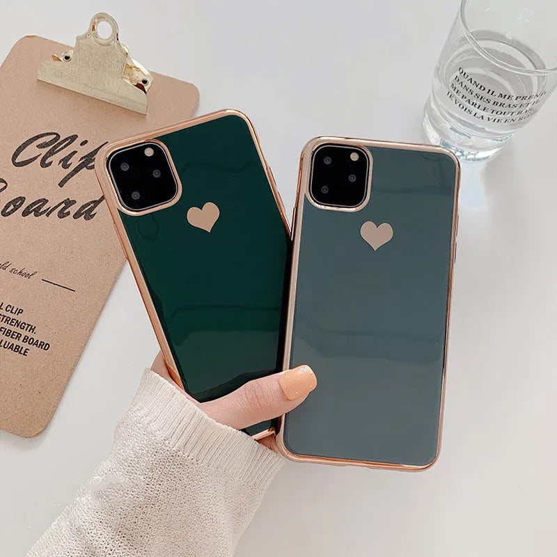 Solid colour TPU back cover case for iPhone on a table, shown in blue, claret, pink, and green.
