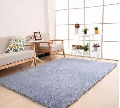 Solid colour fluffy plush carpet with non-slip dots on bottom, shown in beige on a wooden floor.