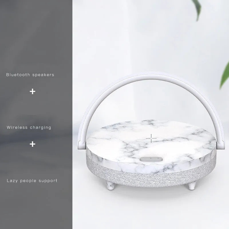 Wireless charging LED night light with Bluetooth speaker and integrated mobile phone holder in marble pattern finish