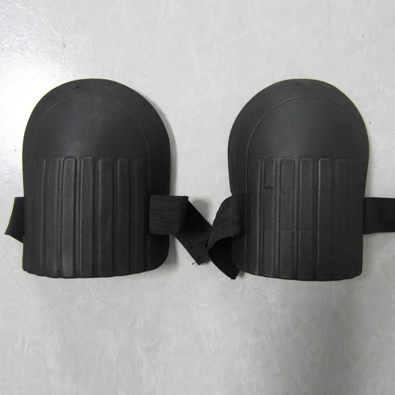A pair of simple black EVA foam knee pads for gardening, showing their rectangular shape and thickness.