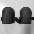 A pair of simple black EVA foam knee pads for gardening, showing their rectangular shape and thickness.