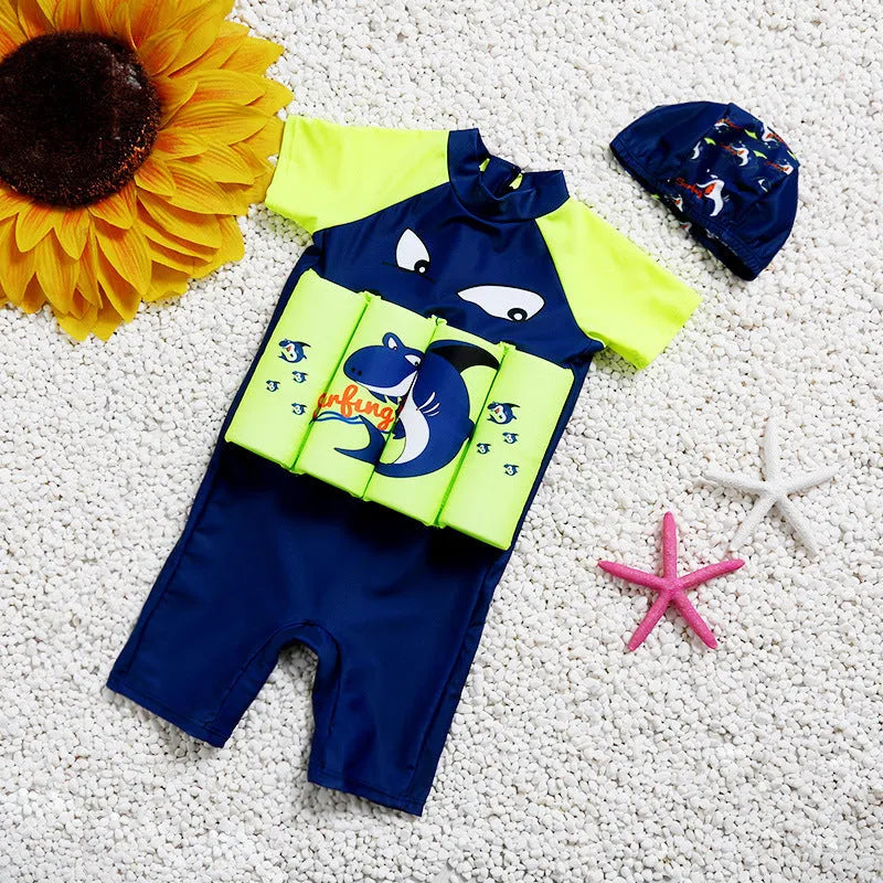 Child wearing a unisex buoyancy swimsuit with a cartoon shark design in a swimming pool.