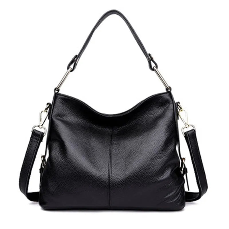 Genuine leather crossbody bag in a vertical square shape with visible sewing lines and a crossbody strap.