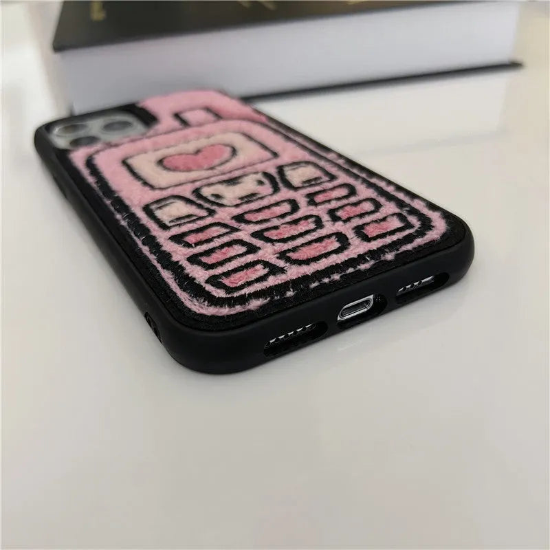 Pink TPU iPhone case with embroidered towel pattern design on the back.