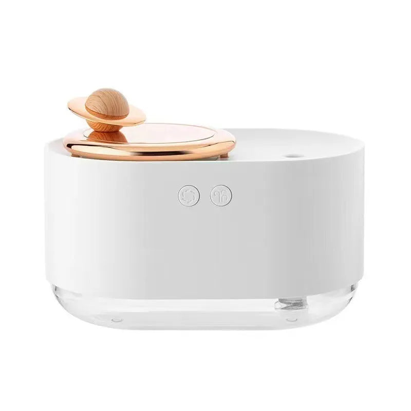 Green rotating planet-shaped car humidifier with night light on a desk next to a USB cable.