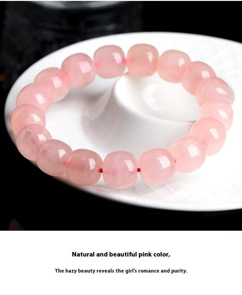 Pink natural crystal barrel bead bracelet with geometric shape on wrist