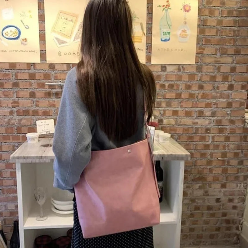 Pink corduroy one-strap shoulder bag with PU lining, showing its 39cm length.