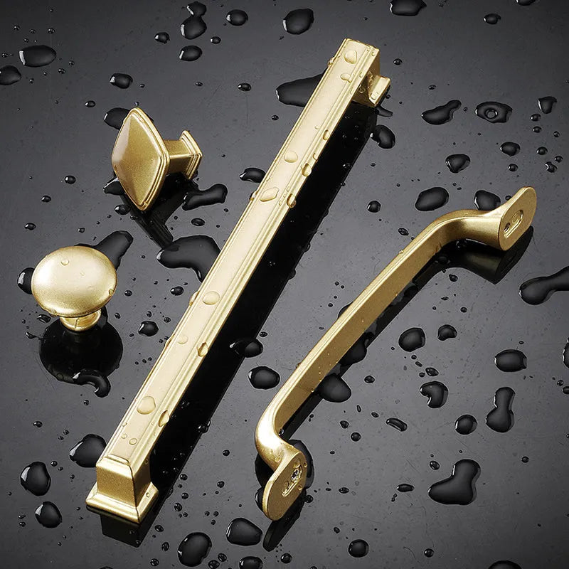 Gold T-shaped aluminium alloy single-hole cabinet door handle on a white background