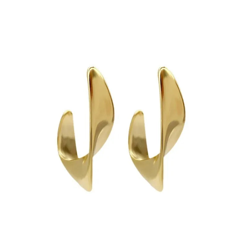 A pair of geometric round earrings with a twisted metal design in a gold electroplated finish.