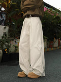 Men's loose-fit pleated trousers in a striped pattern, shown in apricot colour with a straight leg.