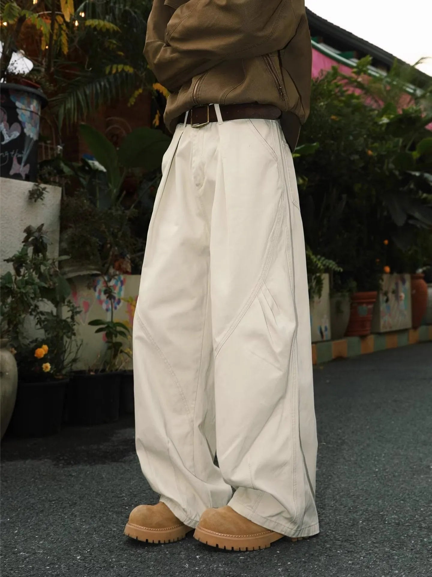 Men's loose-fit pleated trousers in a striped pattern, shown in apricot colour with a straight leg.