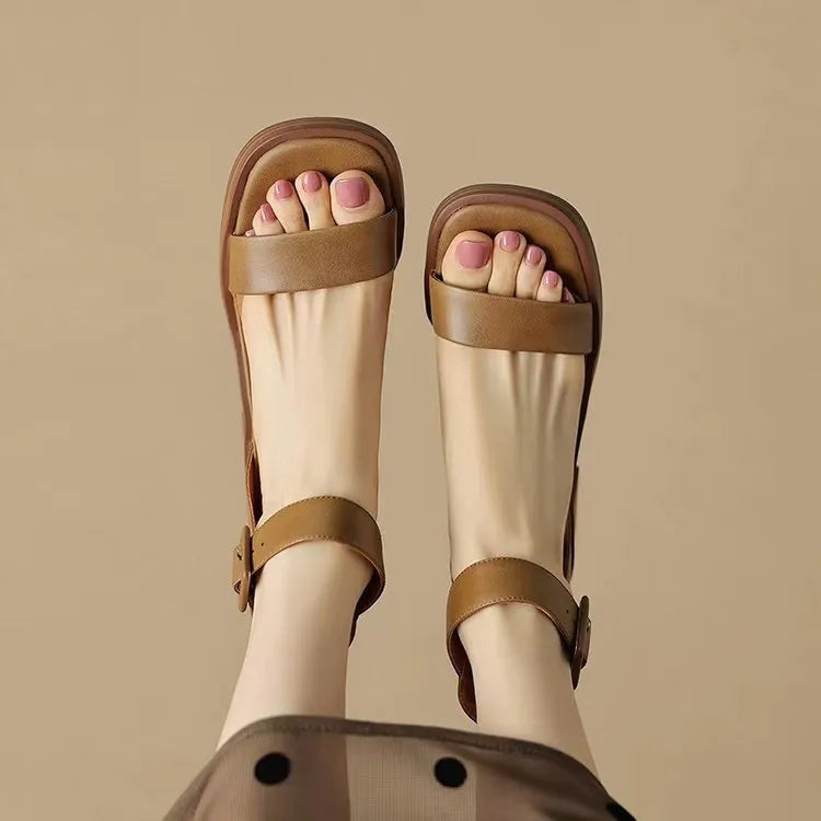White women's platform high heels with an ankle strap and round toe on a plain background.