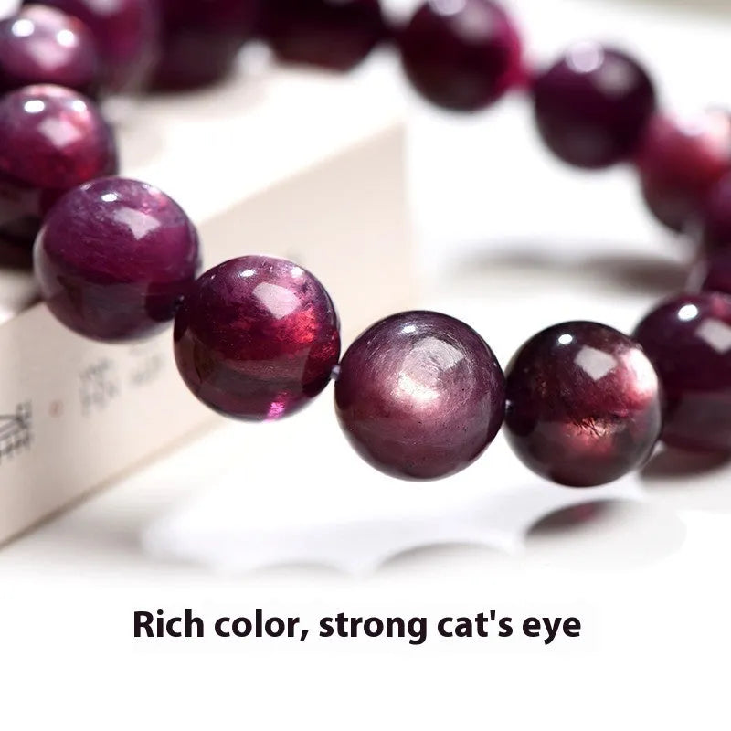 Purple lepidolite crystal round bead bracelet with polished finish on a wrist.