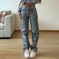 Women's washed blue high-waist straight-leg jeans with silver contrast hardware on a denim background.