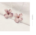 Flower shaped stud earrings in pink or white colour with electroplated alloy construction