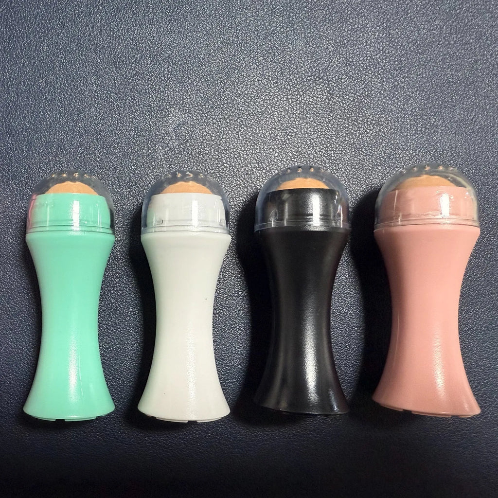 Portable volcanic stone oil absorbing roller in pink on a white background.