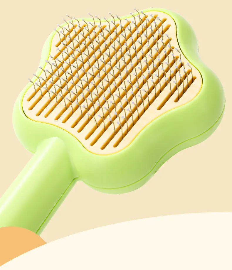 Self-cleaning stainless steel cat comb with green handle, showing 4-row needle design