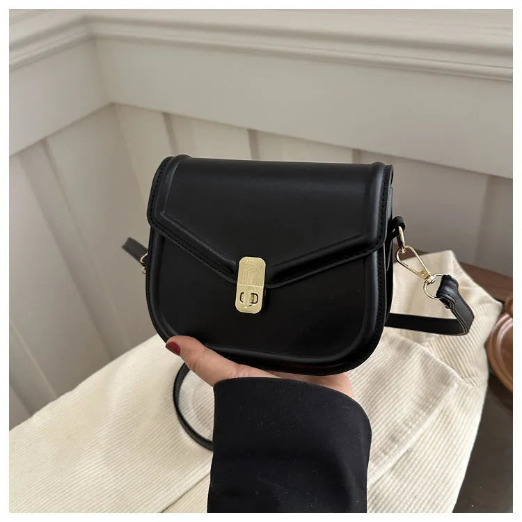 Soft PU leather clamshell messenger bag in a horizontal square shape on a shoulder strap.