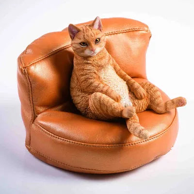 Small resin cat ornament sitting on fabric sofa for car dashboard decoration