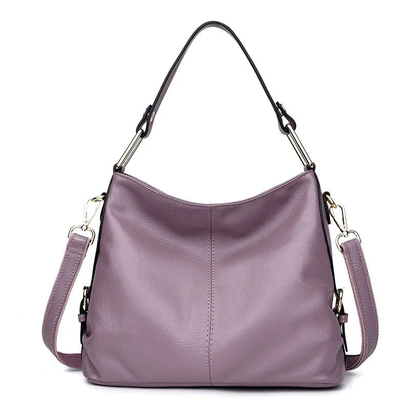 Genuine leather crossbody bag in a vertical square shape with visible sewing lines and a crossbody strap.