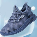 Men's beige casual sneakers with lace-up front, mesh panels, and a flat EVA sole.