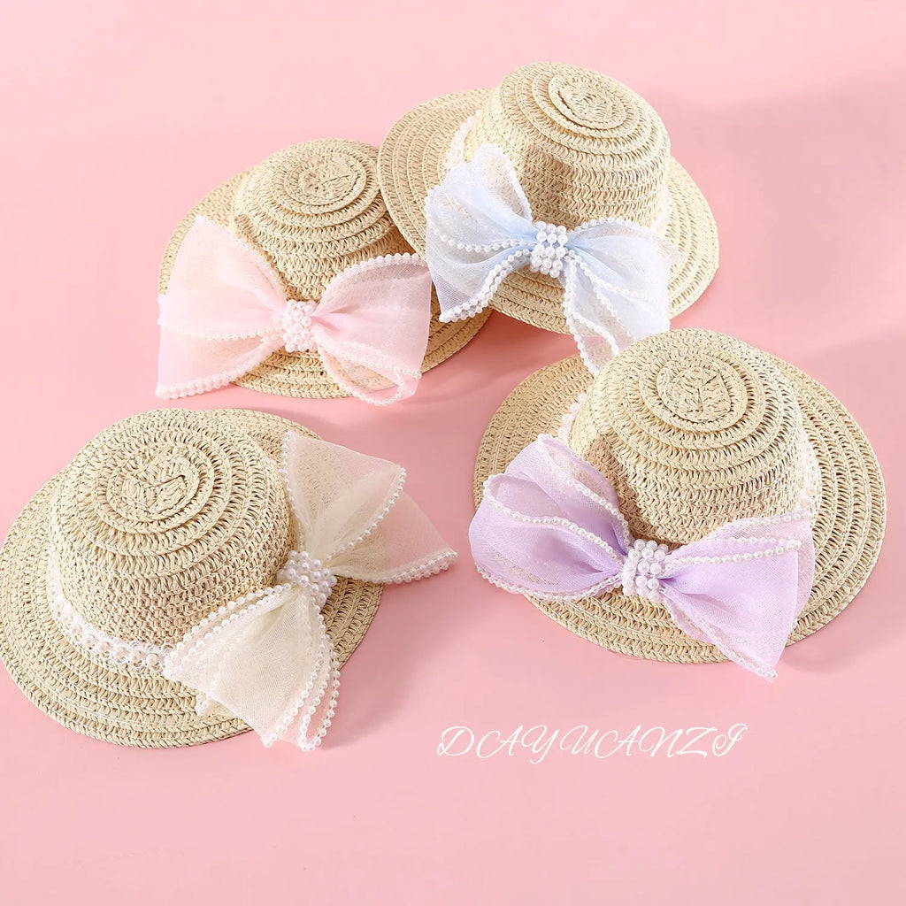 Pink pearl bow woven straw hat for a cat, shown in size S (13cm) on a mannequin head.