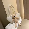 Woven cotton linen shoulder bag in dumpling shape with double straps and three-dimensional pocket.