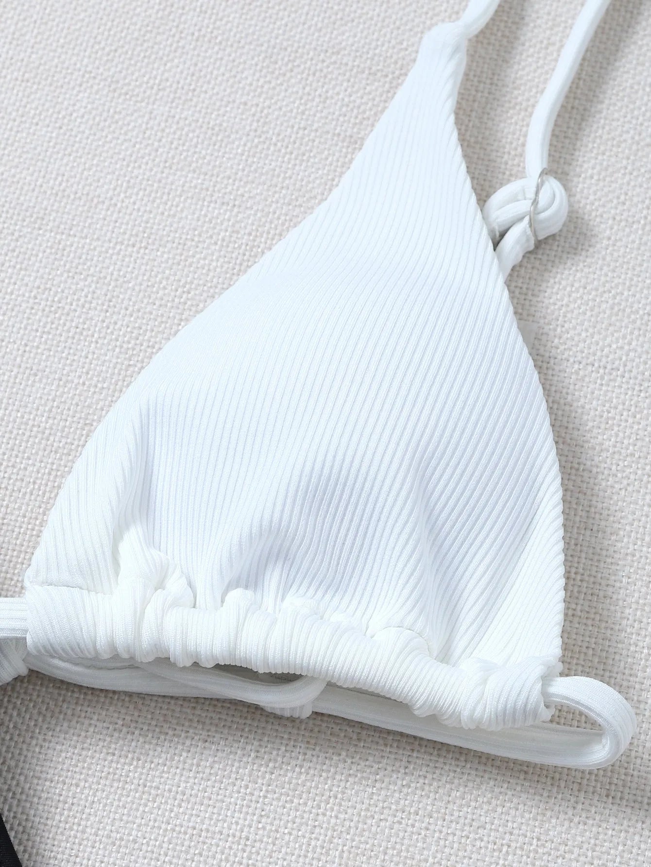 Solid colour bikini with chest pad in black and white, polyester fabric, front view