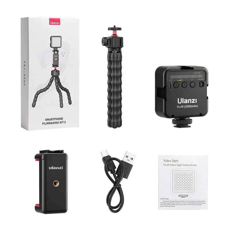 Smartphone mounted on an aluminium tripod with Bluetooth remote and cold shoe adapter for vlogging.