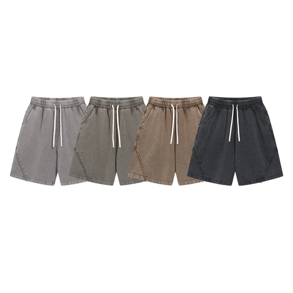 Man wearing batik-washed brown loose-fit cotton terry shorts on a casual street.