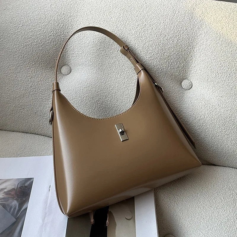 Soft genuine leather dumpling-shaped crossbody shoulder bag in a street style with lock detail