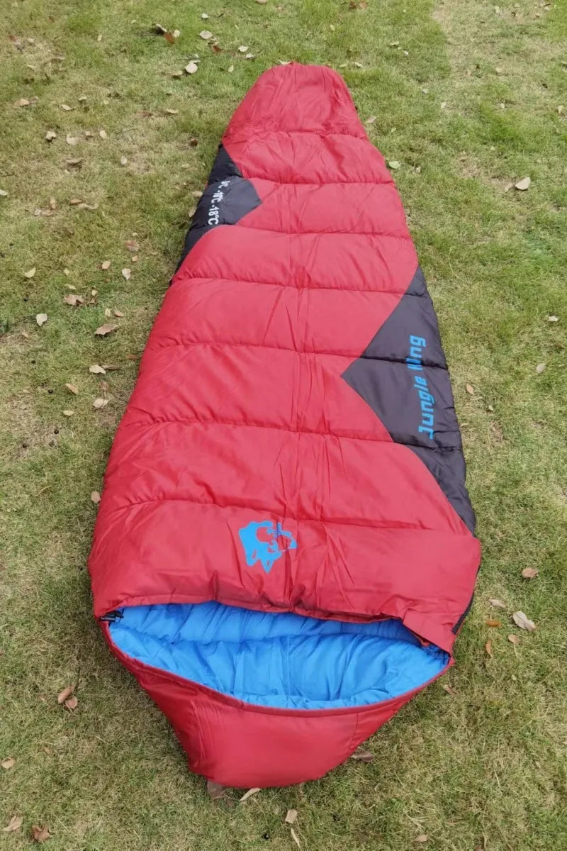 Cotton sleeping bag in Army Green colour compressed inside its storage bag alongside the unfolded sleeping bag.