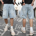 Light blue ripped denim shorts with distressed detailing and straight leg hip hop styling