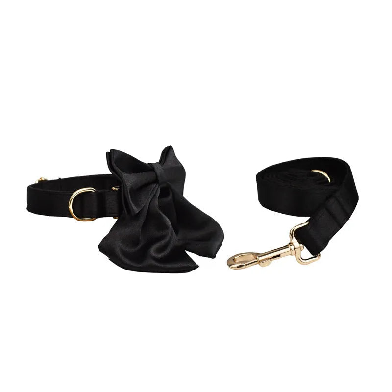 Dog wearing cloth collar, leash, chest harness, decorative bow, and matching vest accessory set