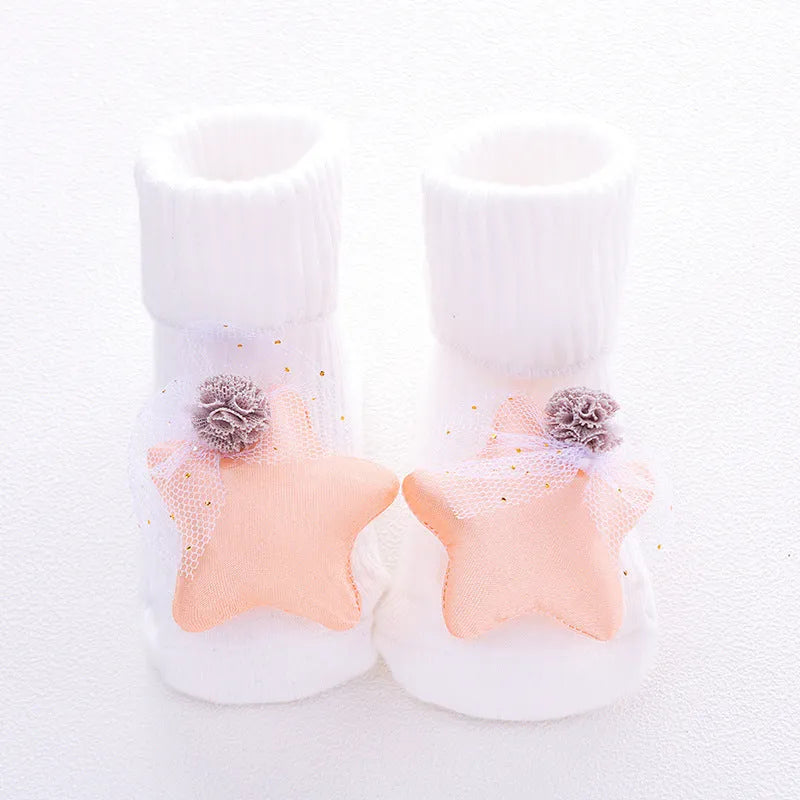 Cotton baby floor socks with non-slip soles in a pink bow print design.
