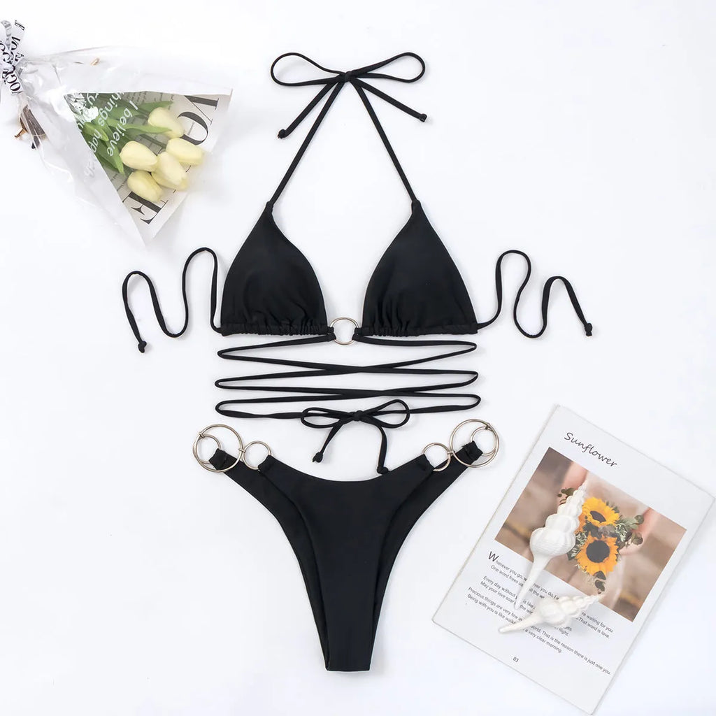 Black women's bikini set with long adjustable straps and metal rings, showing backless and split high-leg design