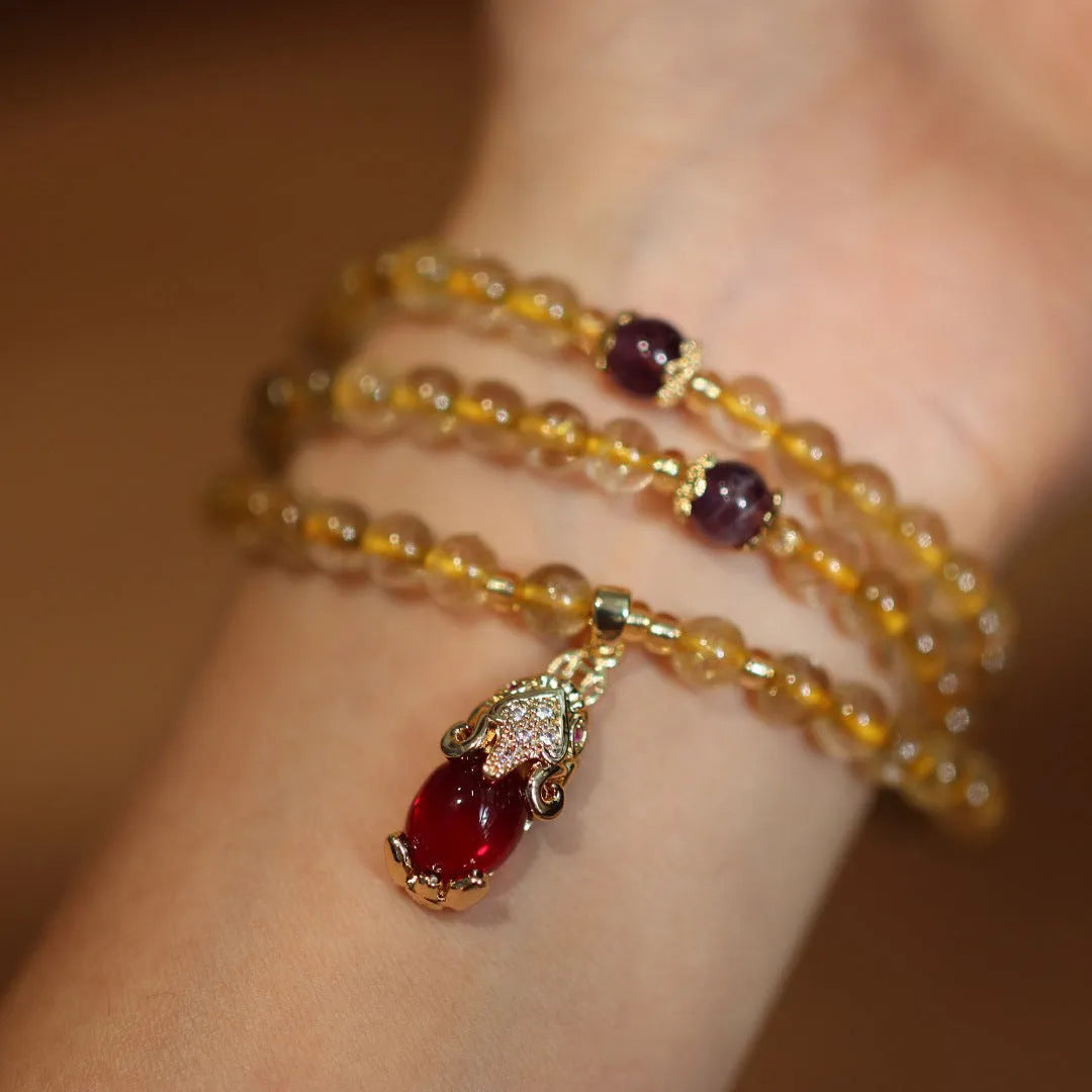 Handmade gold rutilated quartz bracelet with Chinese style design and three-circle pattern.