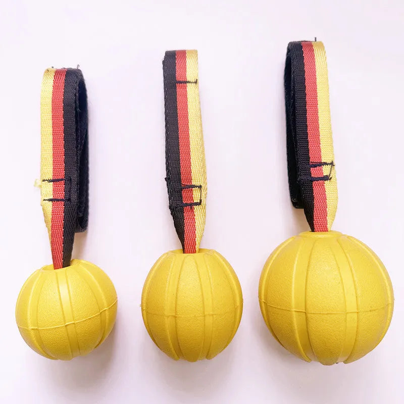Floating EVA pet training ball in camouflage or yellow colours with attached string, shown in 6.5cm, 7cm, and 9cm diameter sizes