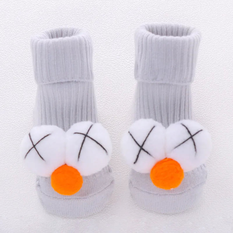 Cotton baby floor socks with non-slip soles in a pink bow print design.