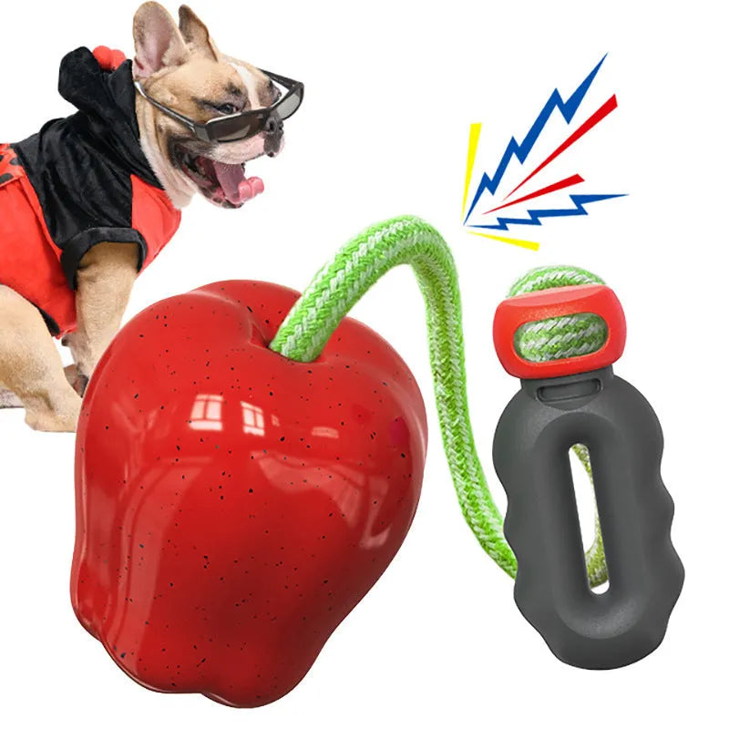 Green and red apple-shaped plastic dog toy with hollow centre for treat dispensing